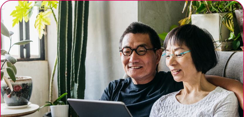 A couple looking at a tablet together at home
